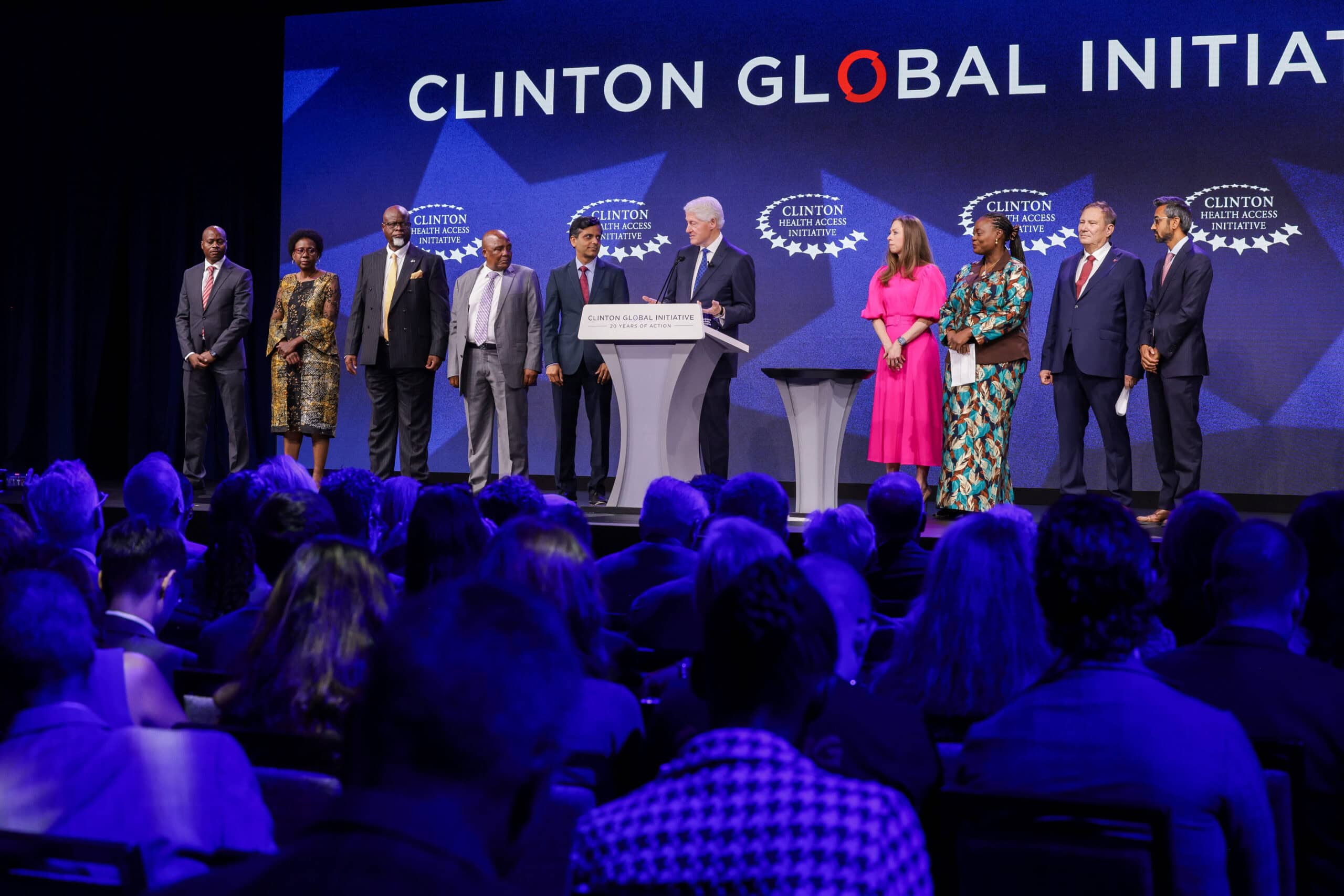 Presenters of the Clinton Global Initiative standing on stage in front of an audience